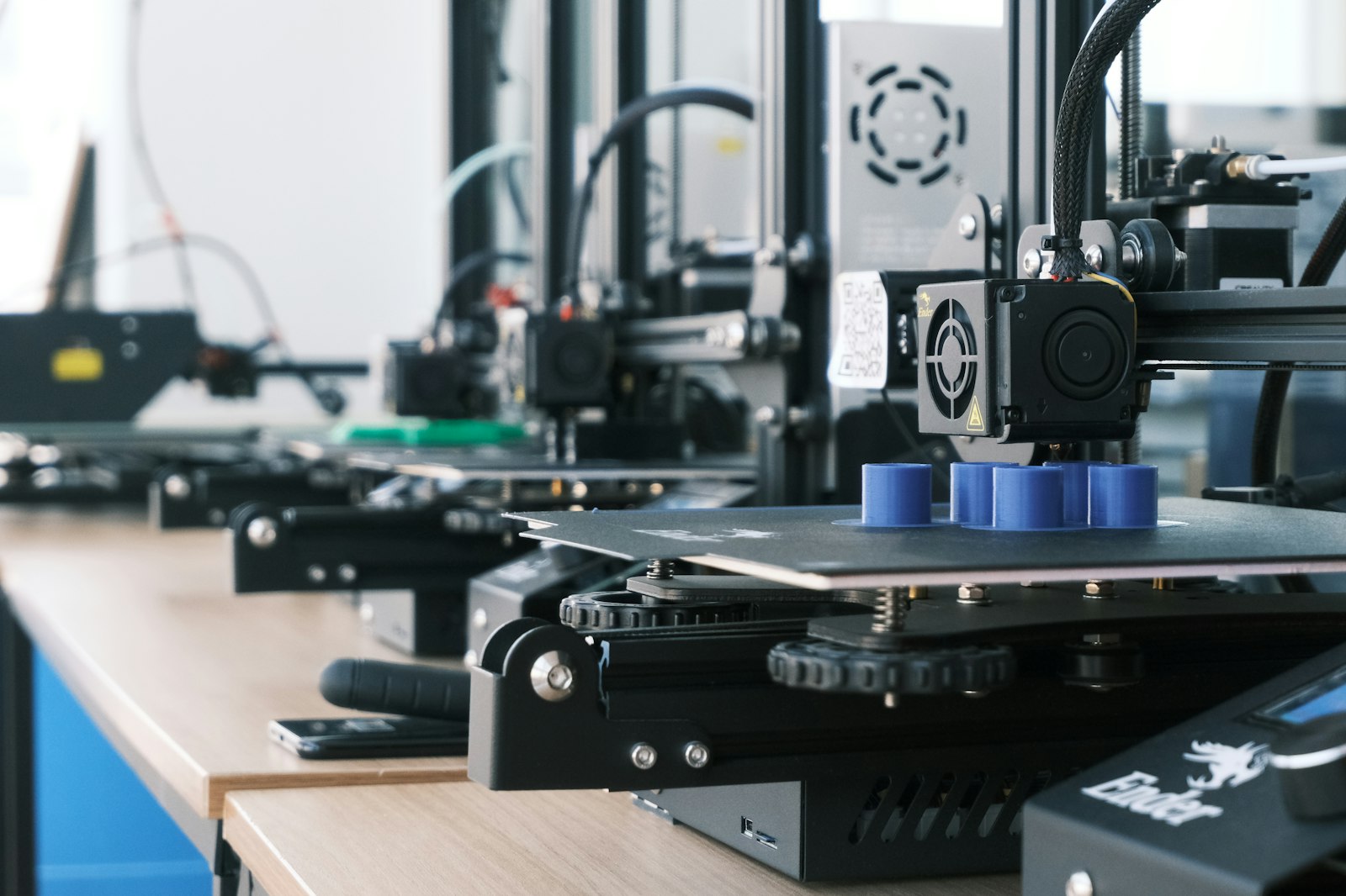 Row of 3D printers producing parts